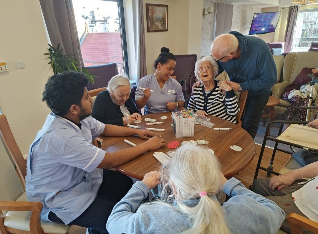 group of our residents sat around the table doing activities